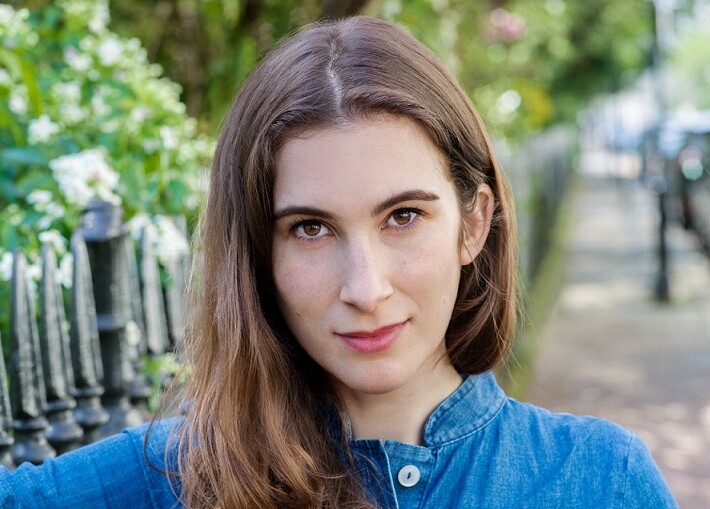 Kate Rundell wearing blue and sitting on park bench