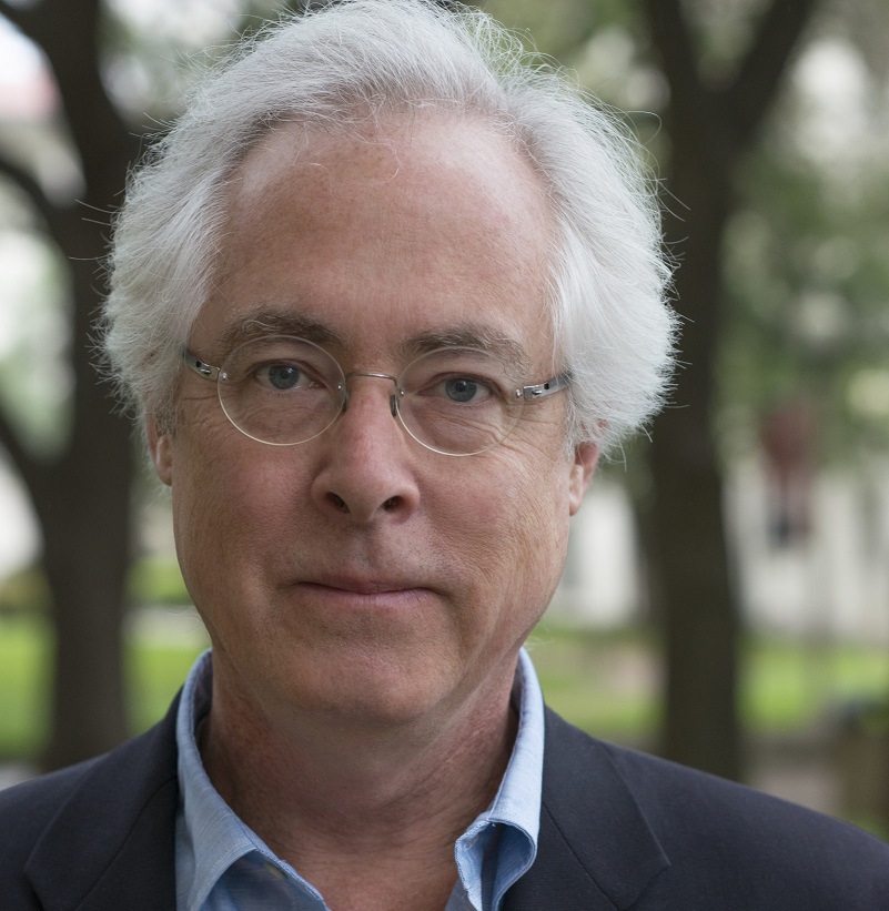 man with white hair and glasses