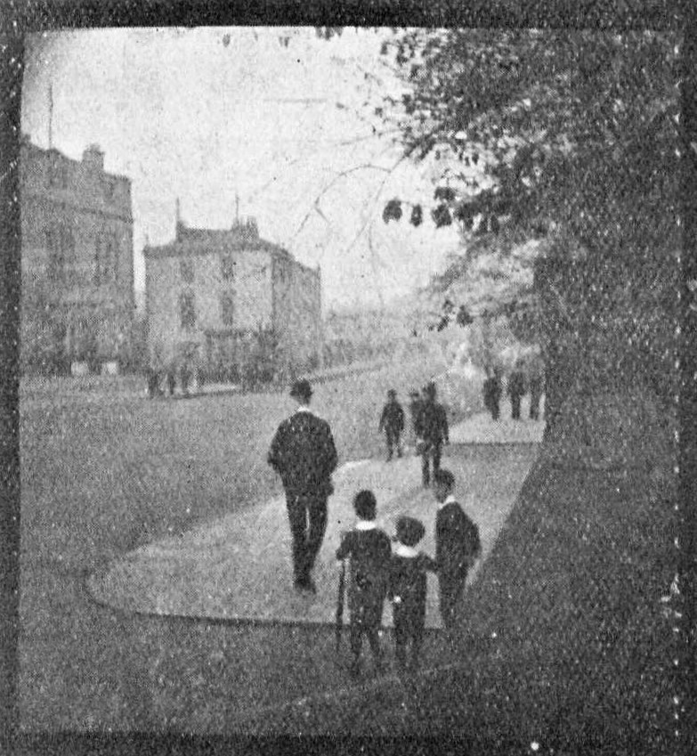 Frame from an early film Friese-Greene shot with his new camera, later reproduced in the Kinematograph and Lantern Weekly. The London location is unknown (possibly by Hyde Park). Visible up both edges are the needle marks of the pinwheel that moved the film through the camera. (Kinematograph and Lantern Weekly, 15 July 1909).